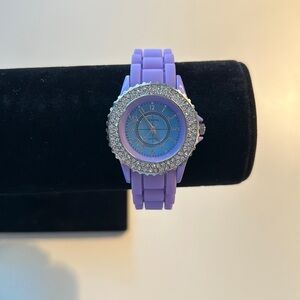 Purple watch with crystal face.